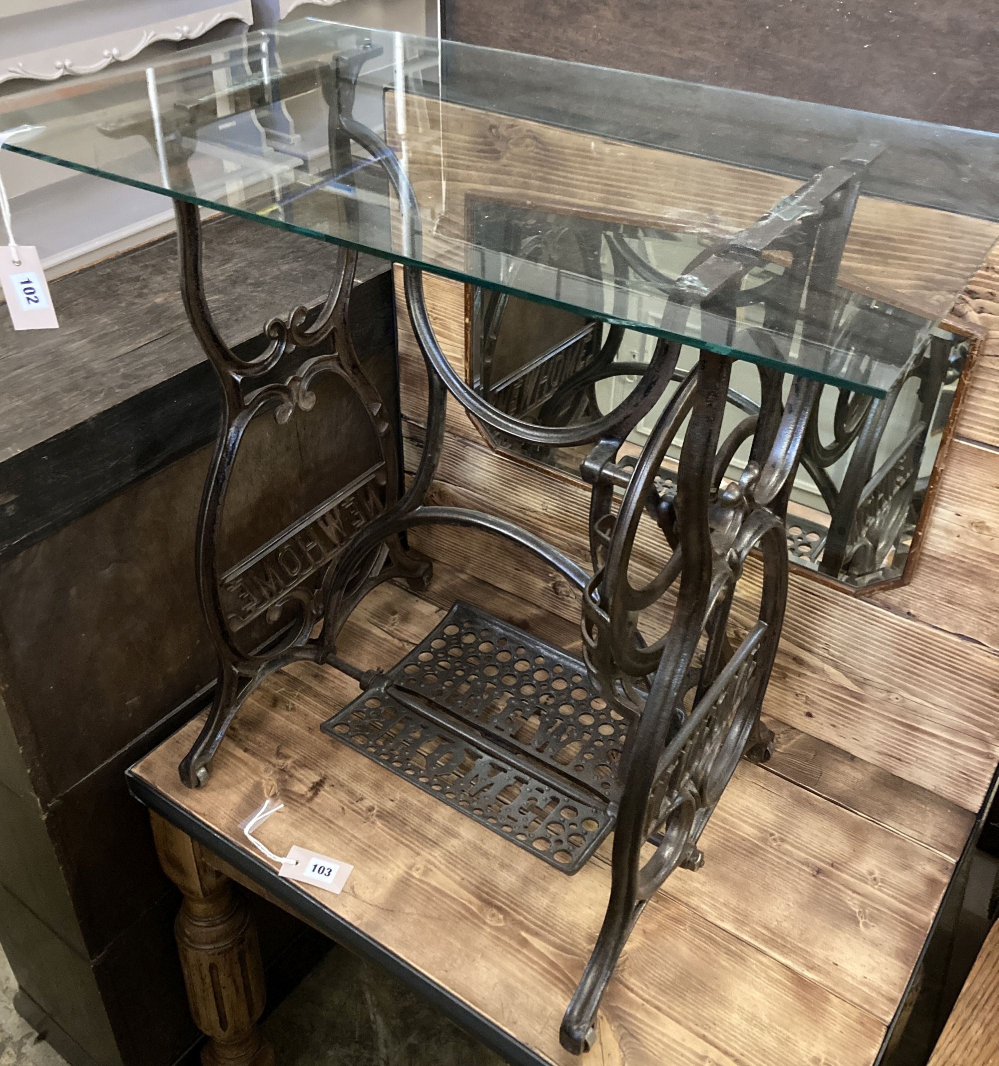A Victorian Newhome cast iron treadle sewing machine base now as a glass top occasional table, width 75cm, depth 45cm, height 72cm